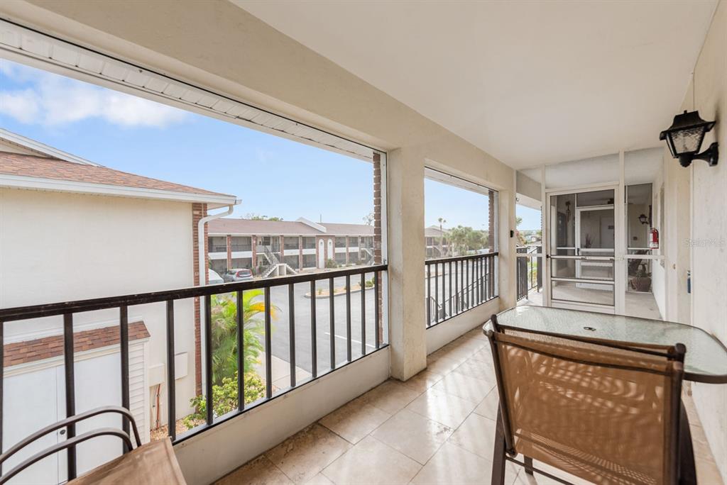 1531 Placida Road, Unit 1204 Englewood, FL 34223 - Photo 35 of 58 a view of a porch with wooden floor and windows