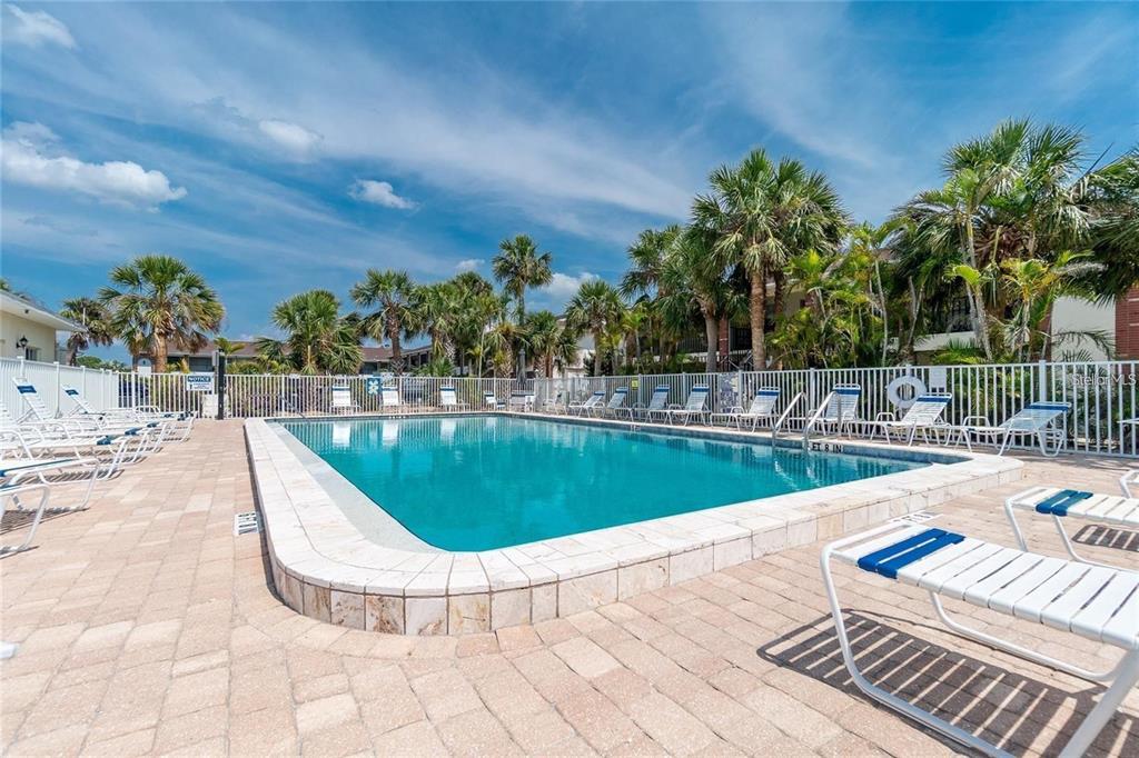 1531 Placida Road, Unit 1204 Englewood, FL 34223 - Photo 36 of 58 a view of a swimming pool with a lounge chair