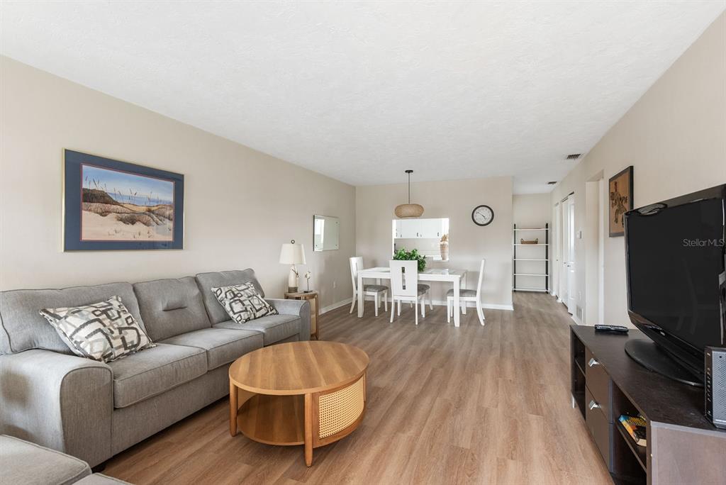 1531 Placida Road, Unit 1204 Englewood, FL 34223 - Photo 6 of 58 a living room with furniture and a flat screen tv