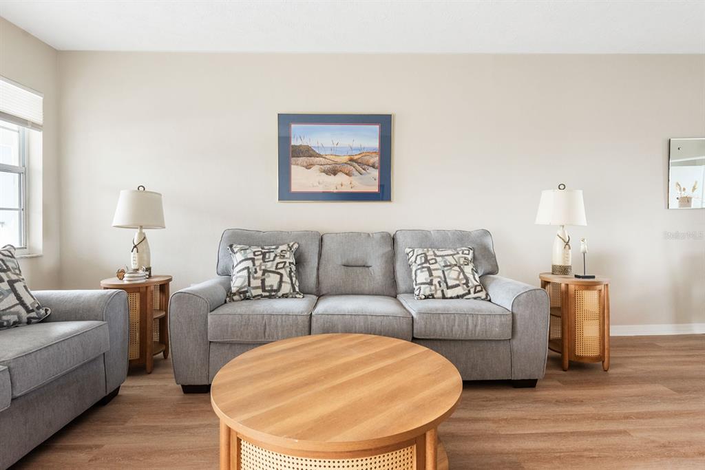 1531 Placida Road, Unit 1204 Englewood, FL 34223 - Photo 7 of 58 a living room with furniture and a wooden floor