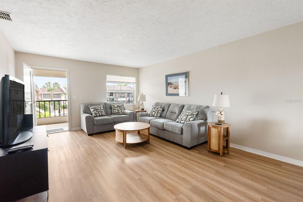 1531 Placida Road, Unit 1204 Englewood, FL 34223 - Photo 8 of 58 a living room with furniture and a flat screen tv