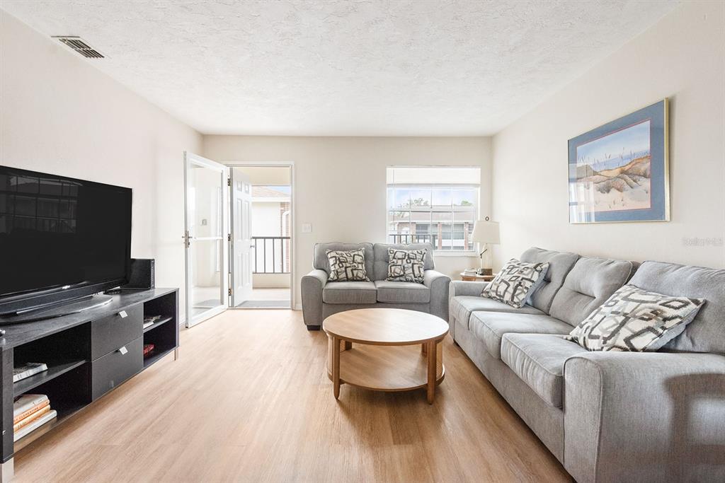 1531 Placida Road, Unit 1204 Englewood, FL 34223 - Photo 9 of 58 a living room with furniture and a flat screen tv
