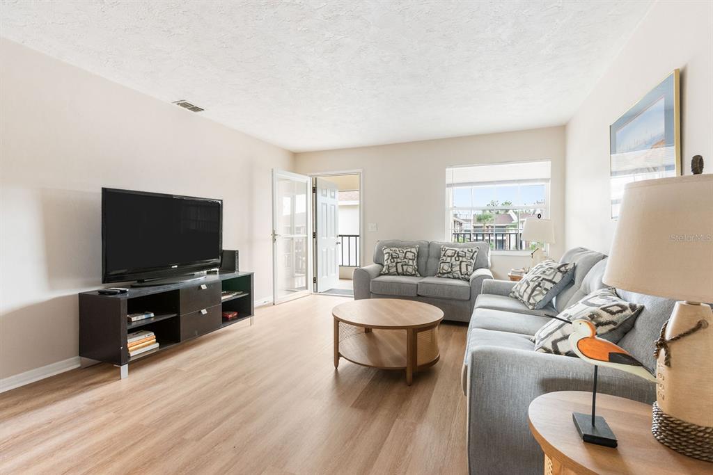 1531 Placida Road, Unit 1204 Englewood, FL 34223 - Photo 10 of 58 a living room with furniture and a flat screen tv