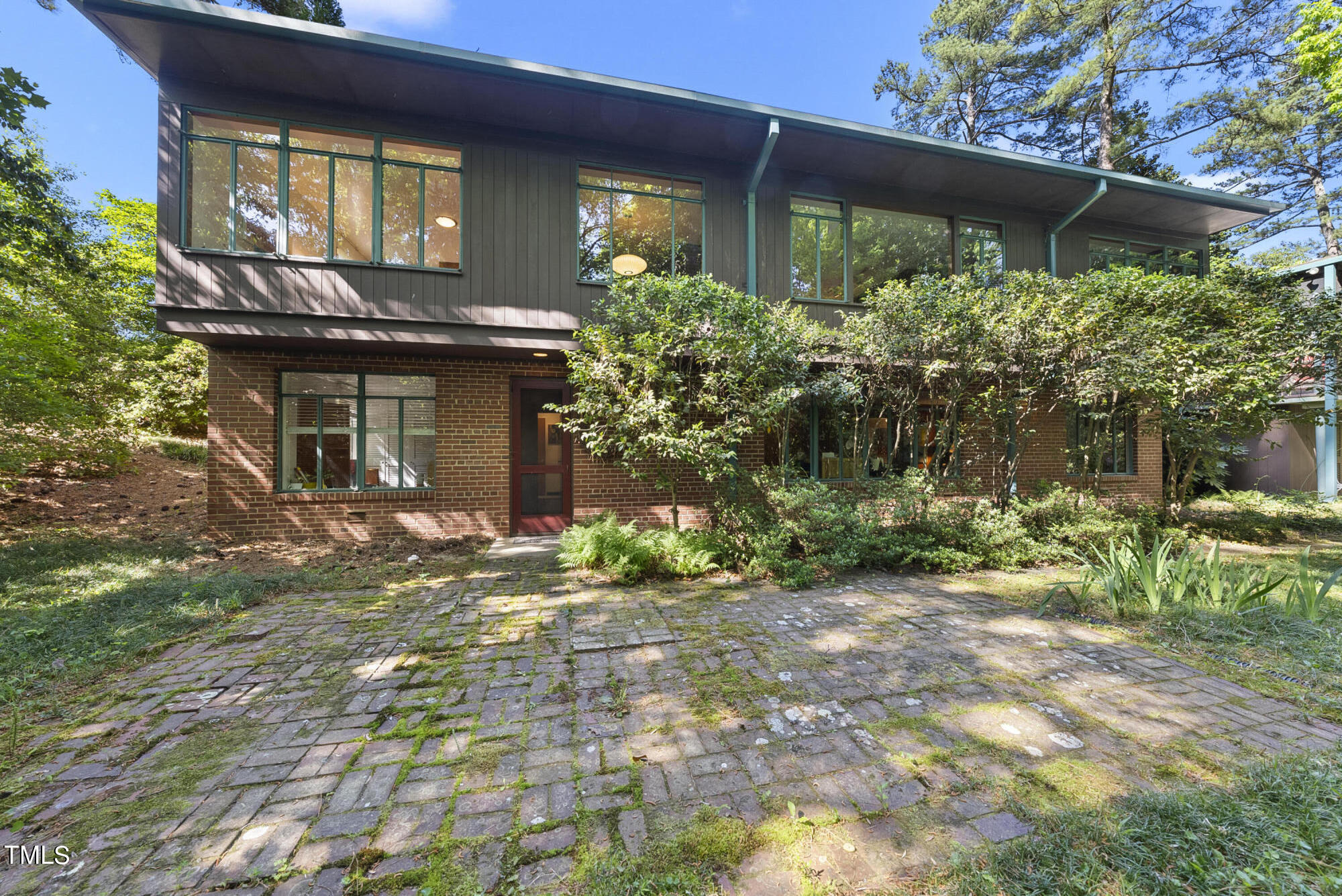 2715 Rosedale Avenue Raleigh, NC 27607 - Photo 1 of 46 Rear of home - Large overhangs, bands of original steel casement windows and two exterior doors from lower level lead to the lush back yard