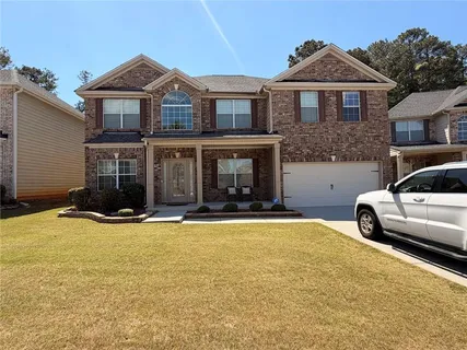a front view of a house with yard