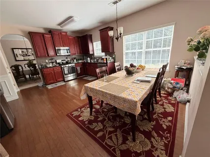 a view of a dining room with furniture window and wooden floor