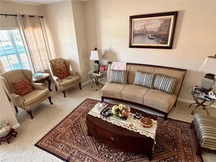 a living room with furniture rug and window