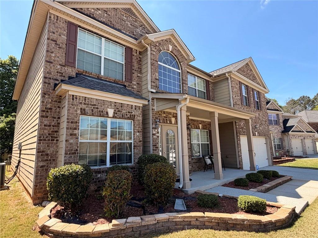 4080 Kittery Point Southwest Snellville, GA 30039 - Photo 23 of 25 a front view of a house with garden