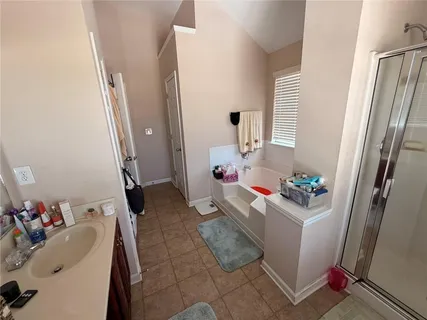 a room with a sink washer and dryer