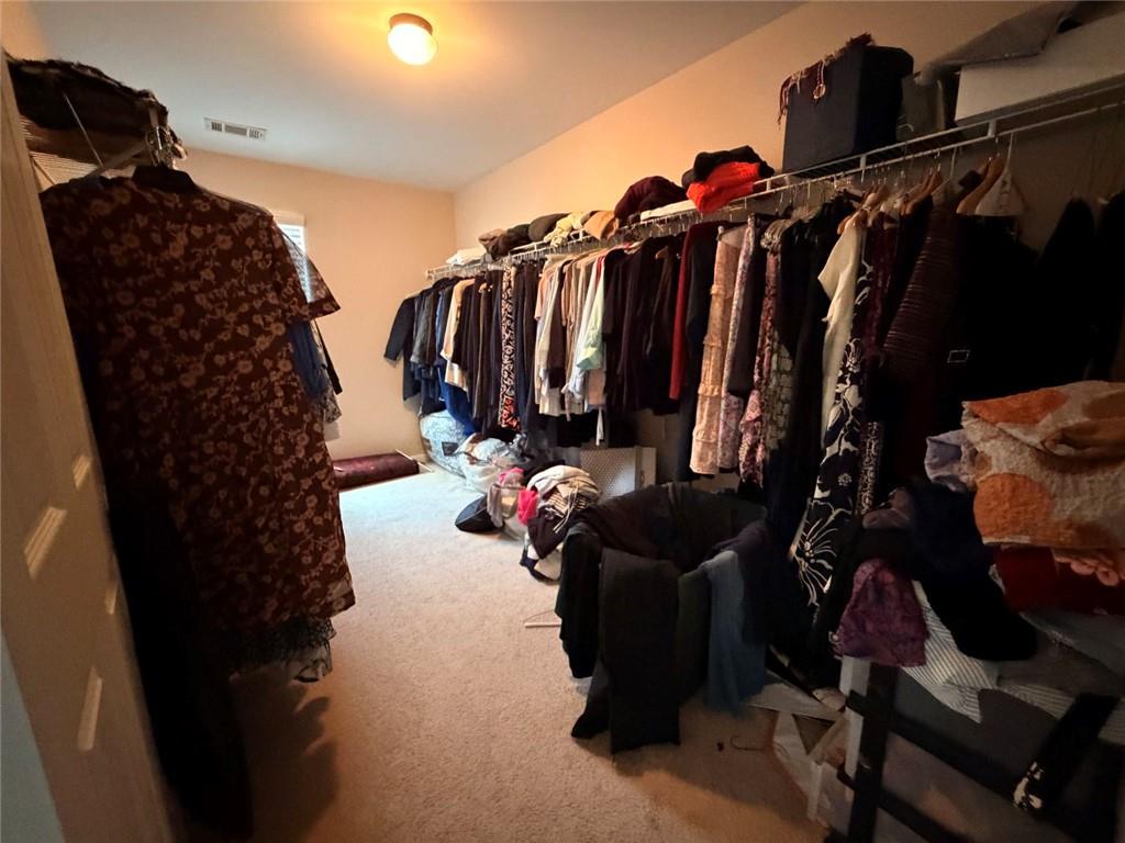 4080 Kittery Point Southwest Snellville, GA 30039 - Photo 5 of 25 a view of walk in closet with clothes and shoes