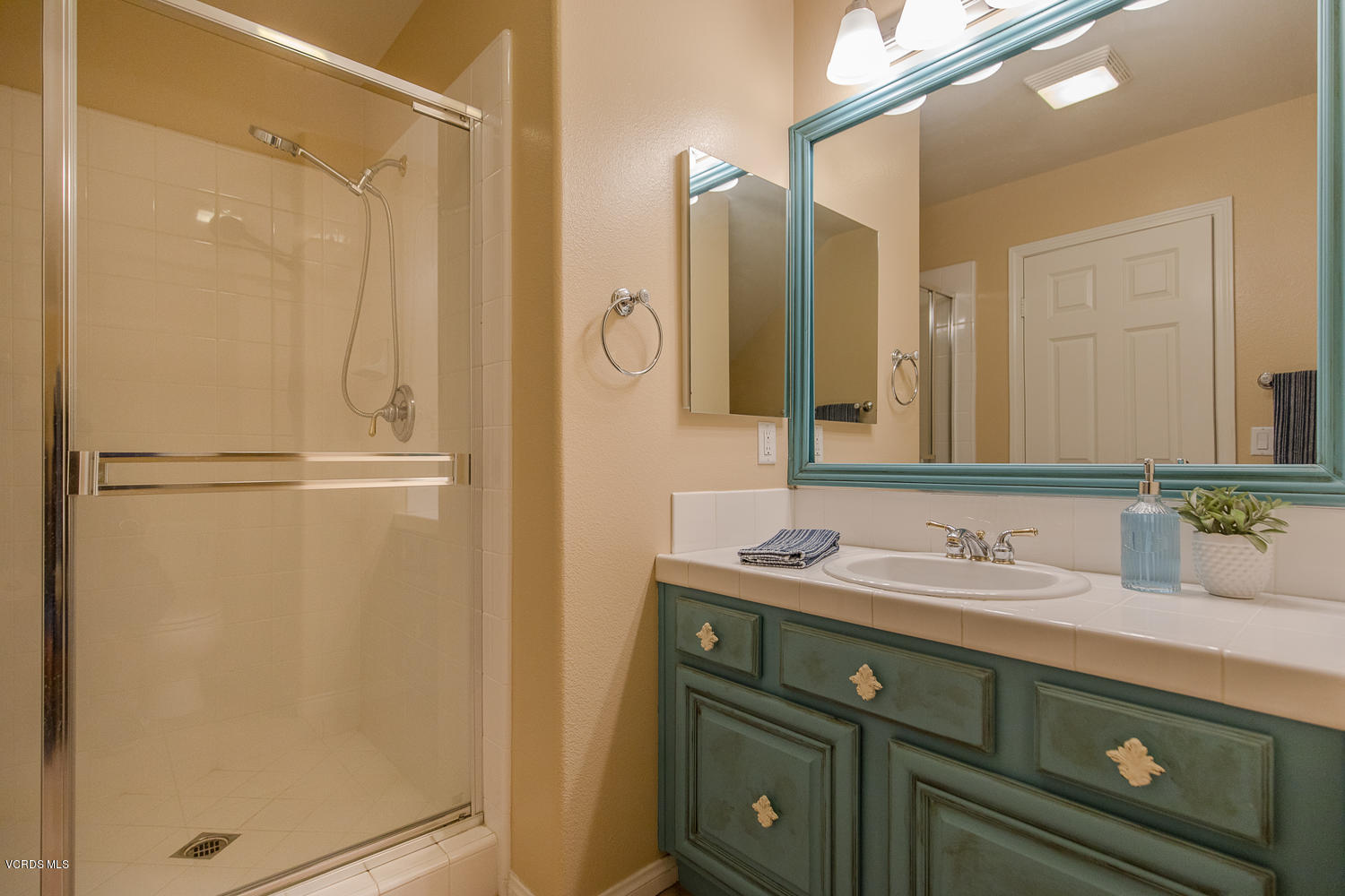 14410 Peach Hill Road Moorpark, CA 93021 - Photo 26 of 45 a bathroom with a sink and a mirror