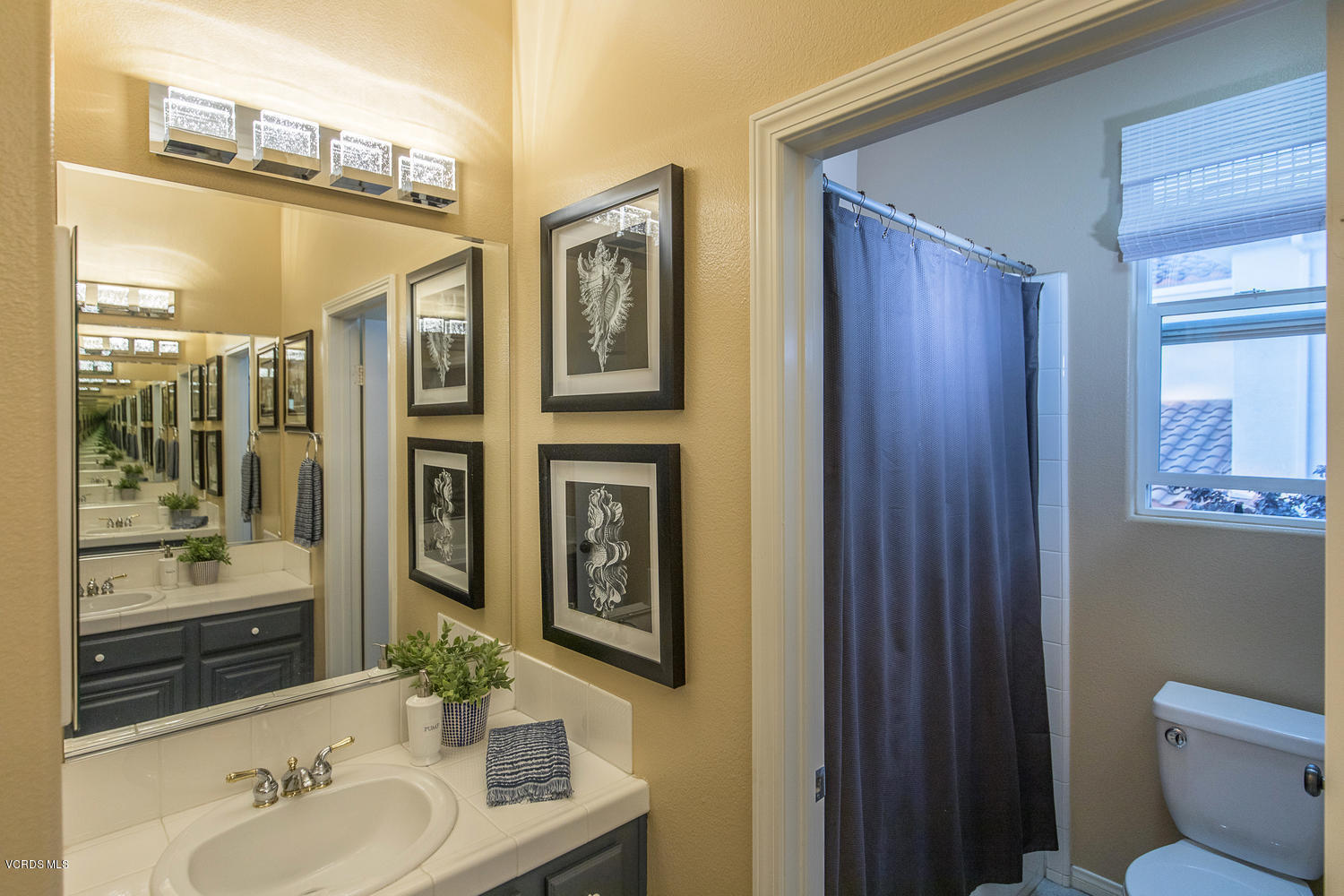 14410 Peach Hill Road Moorpark, CA 93021 - Photo 32 of 45 a bathroom with a sink and a mirror