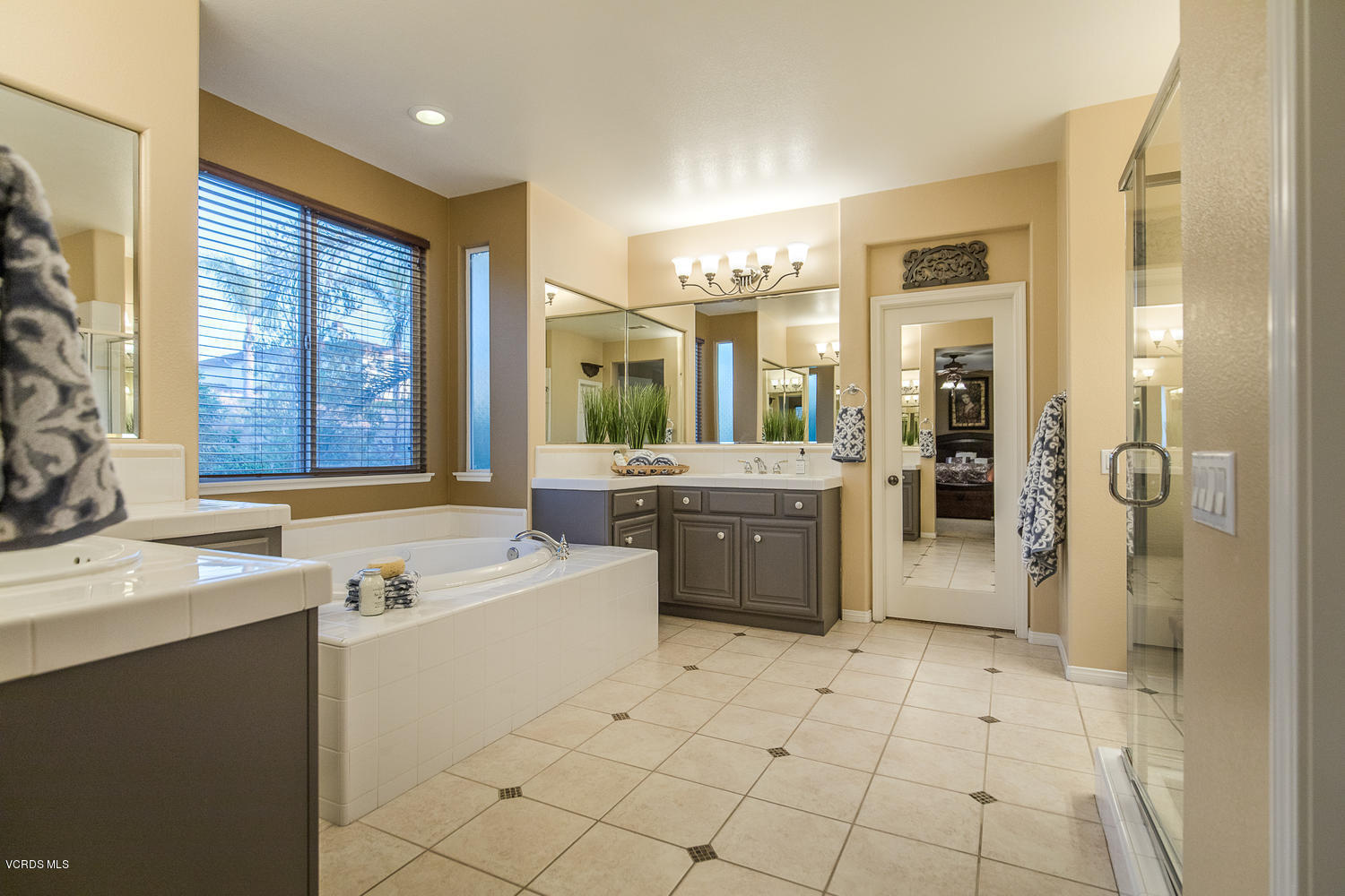 14410 Peach Hill Road Moorpark, CA 93021 - Photo 36 of 45 a large bathroom with a double vanity sink a mirror and a shower