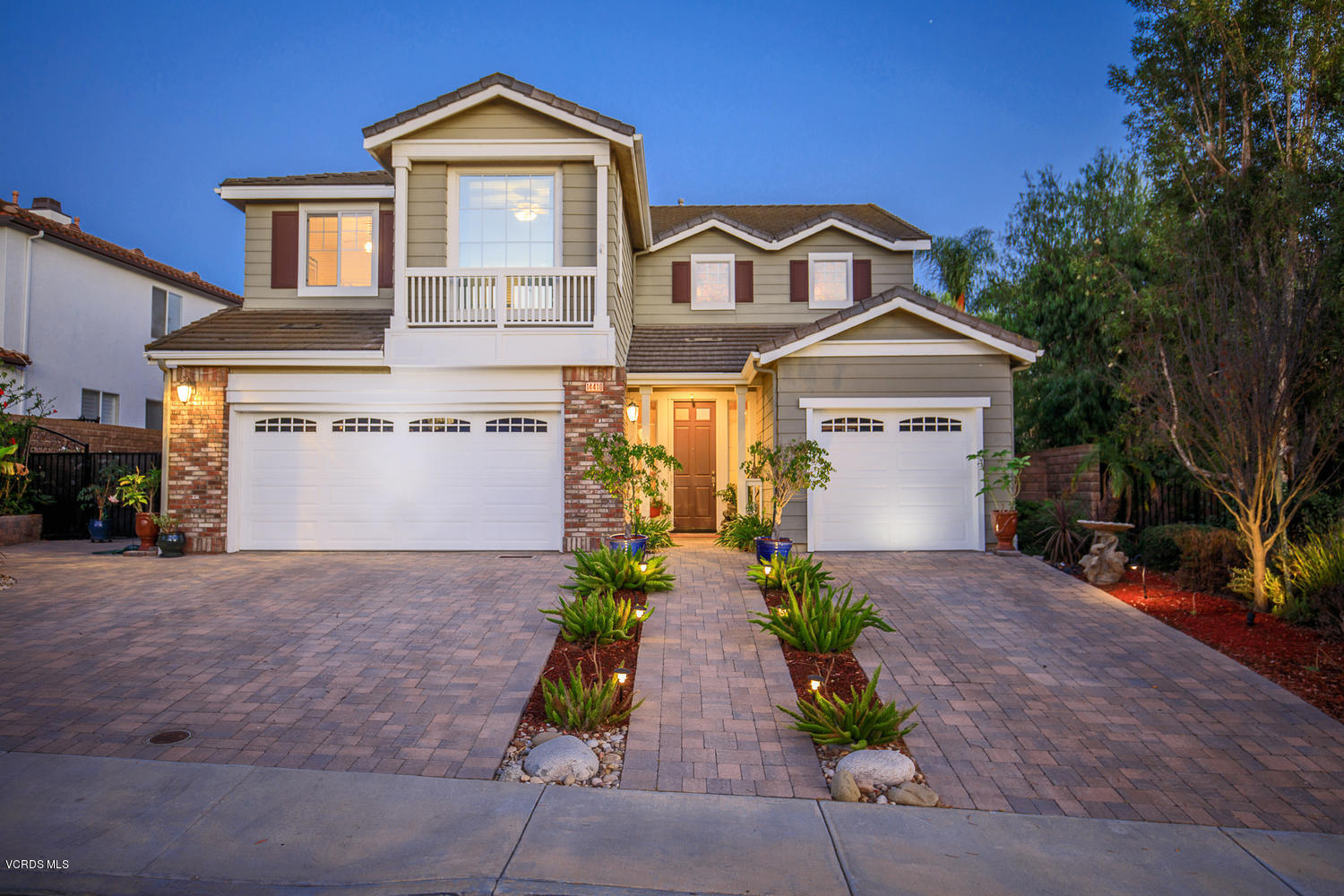 14410 Peach Hill Road Moorpark, CA 93021 - Photo 7 of 45 a front view of a house with a yard and garage