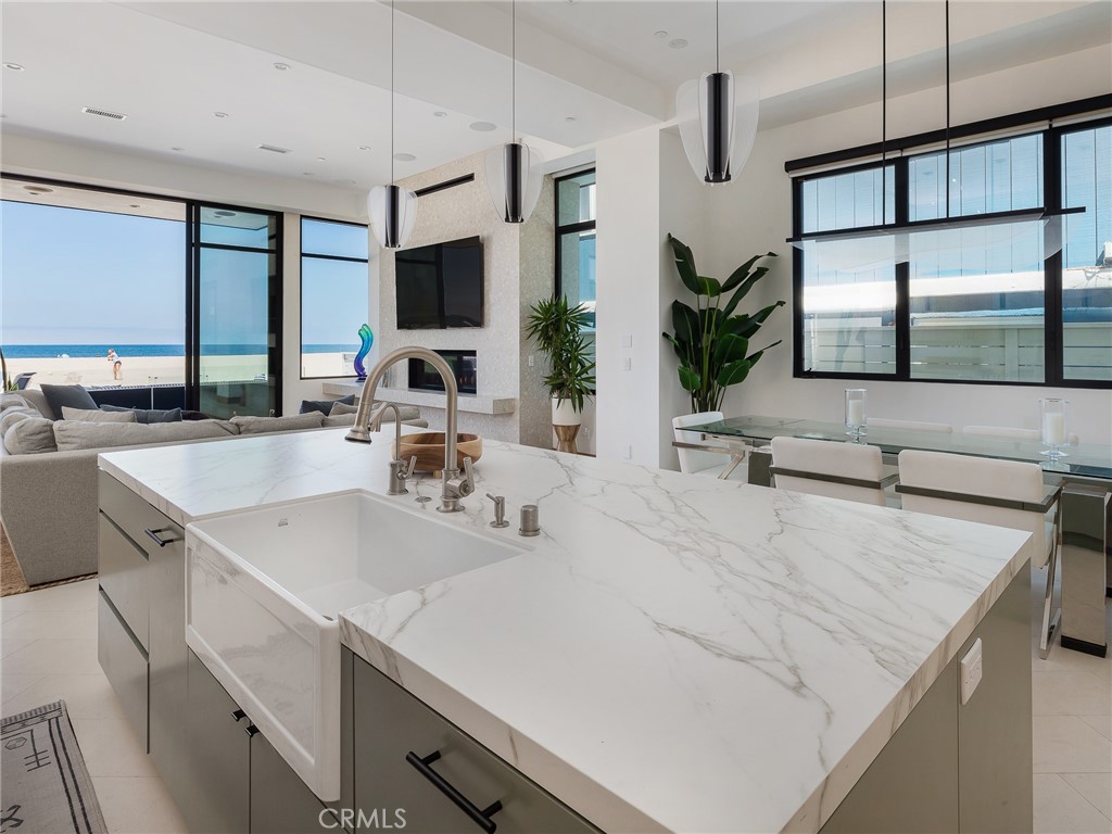 230 The Strand Hermosa Beach, CA 90254 - Photo 16 of 72 a view of a kitchen with a sink a counter top space and living room view