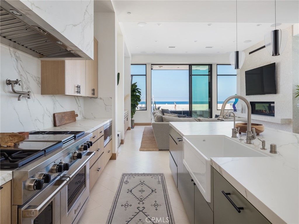 230 The Strand Hermosa Beach, CA 90254 - Photo 17 of 72 a large kitchen with stainless steel appliances granite countertop a sink stove and refrigerator