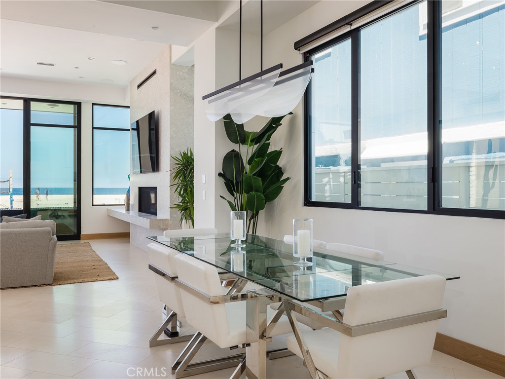 230 The Strand Hermosa Beach, CA 90254 - Photo 22 of 72 a dining room with furniture and a potted plant