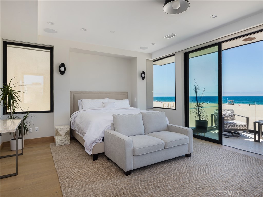 230 The Strand Hermosa Beach, CA 90254 - Photo 23 of 72 a bedroom with a bed couch and large window