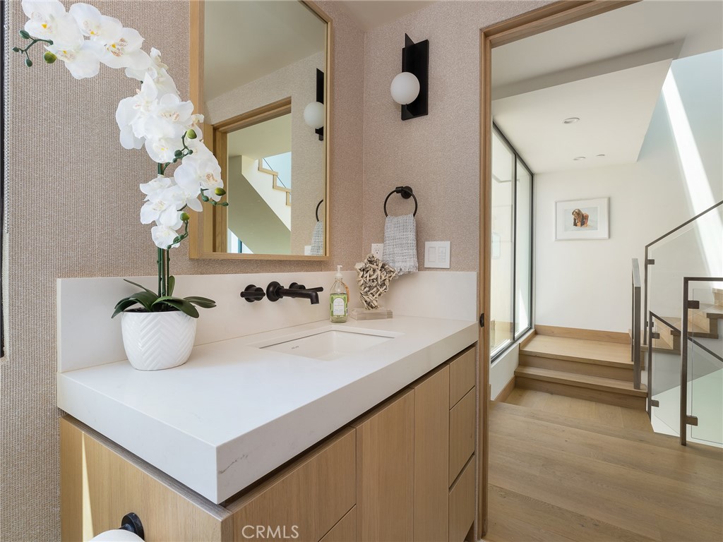 230 The Strand Hermosa Beach, CA 90254 - Photo 36 of 72 a bathroom with a sink vanity and a mirror