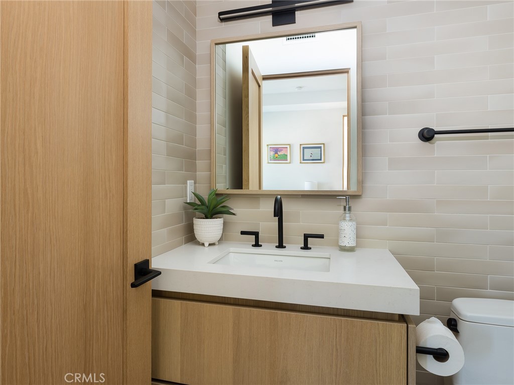 230 The Strand Hermosa Beach, CA 90254 - Photo 39 of 72 a bathroom with a sink a toilet and mirror
