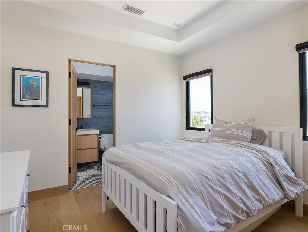 230 The Strand Hermosa Beach, CA 90254 - Photo 41 of 72 a bedroom with a bed and a window