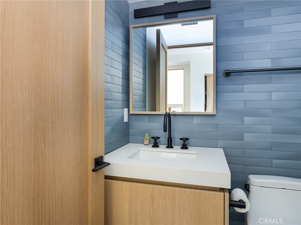 230 The Strand Hermosa Beach, CA 90254 - Photo 42 of 72 a bathroom with a sink and a toilet