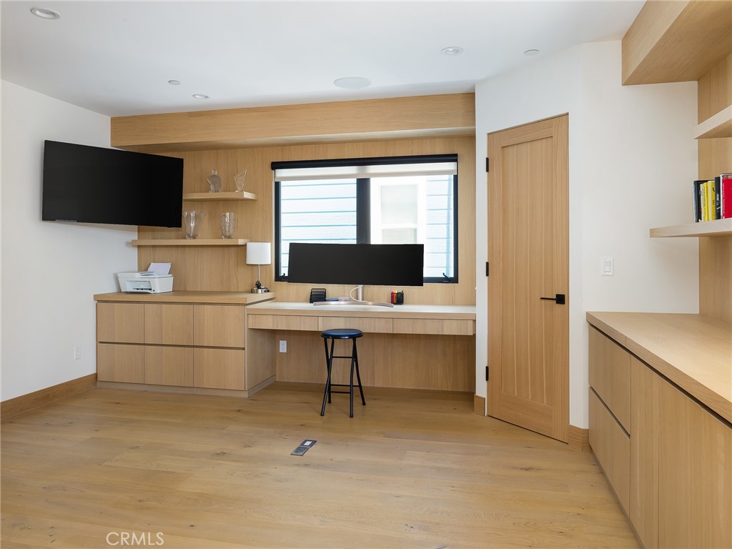 230 The Strand Hermosa Beach, CA 90254 - Photo 46 of 72 a view of a livingroom with workspace and a flat screen tv