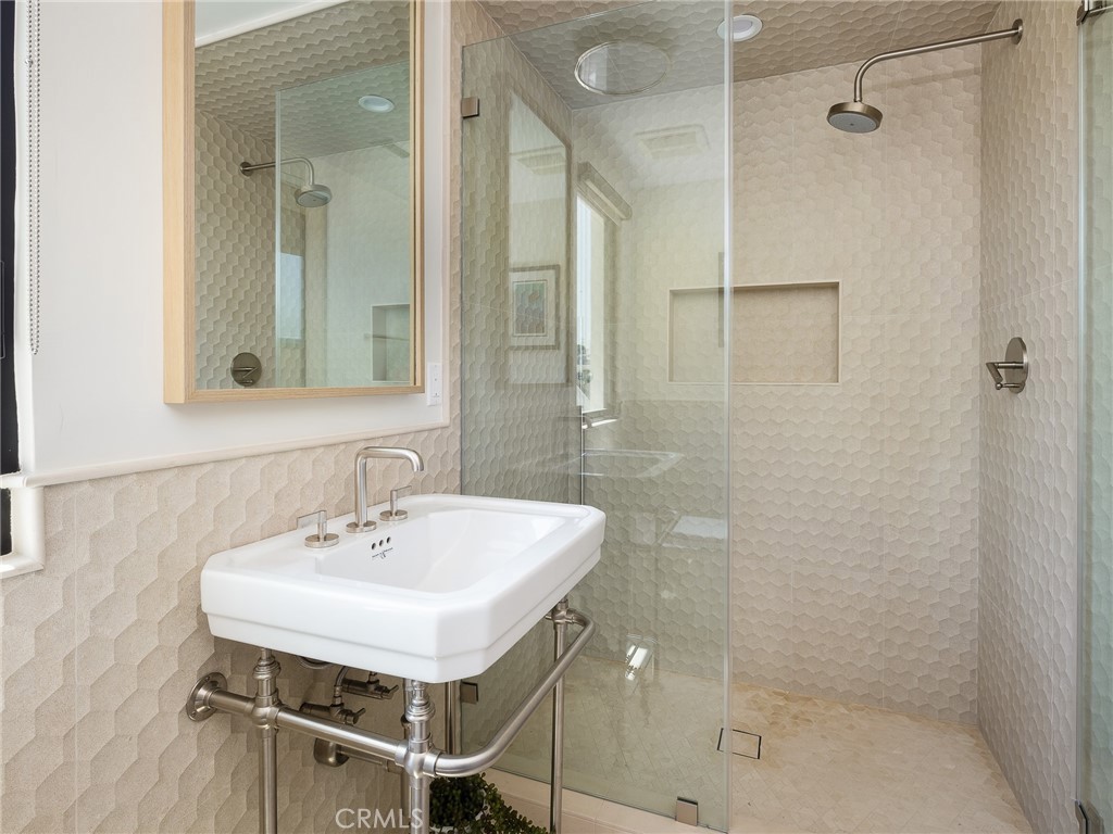 230 The Strand Hermosa Beach, CA 90254 - Photo 47 of 72 a bathroom with a sink shower and a mirror