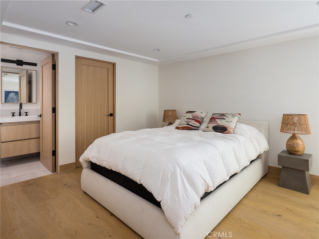 230 The Strand Hermosa Beach, CA 90254 - Photo 54 of 72 a bedroom with a bed and a lamp