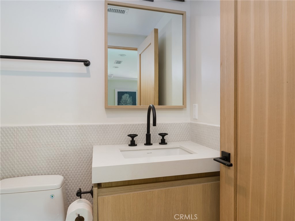 230 The Strand Hermosa Beach, CA 90254 - Photo 55 of 72 a bathroom with a sink and a toilet
