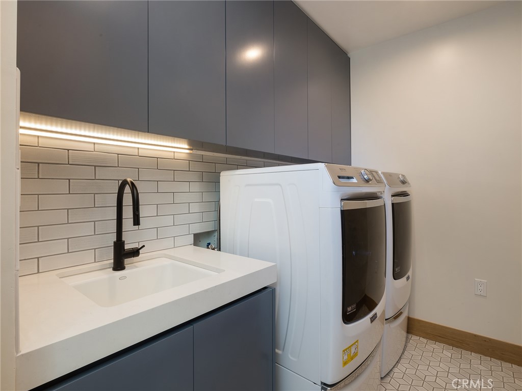 230 The Strand Hermosa Beach, CA 90254 - Photo 57 of 72 a bathroom with a sink and a washing machine