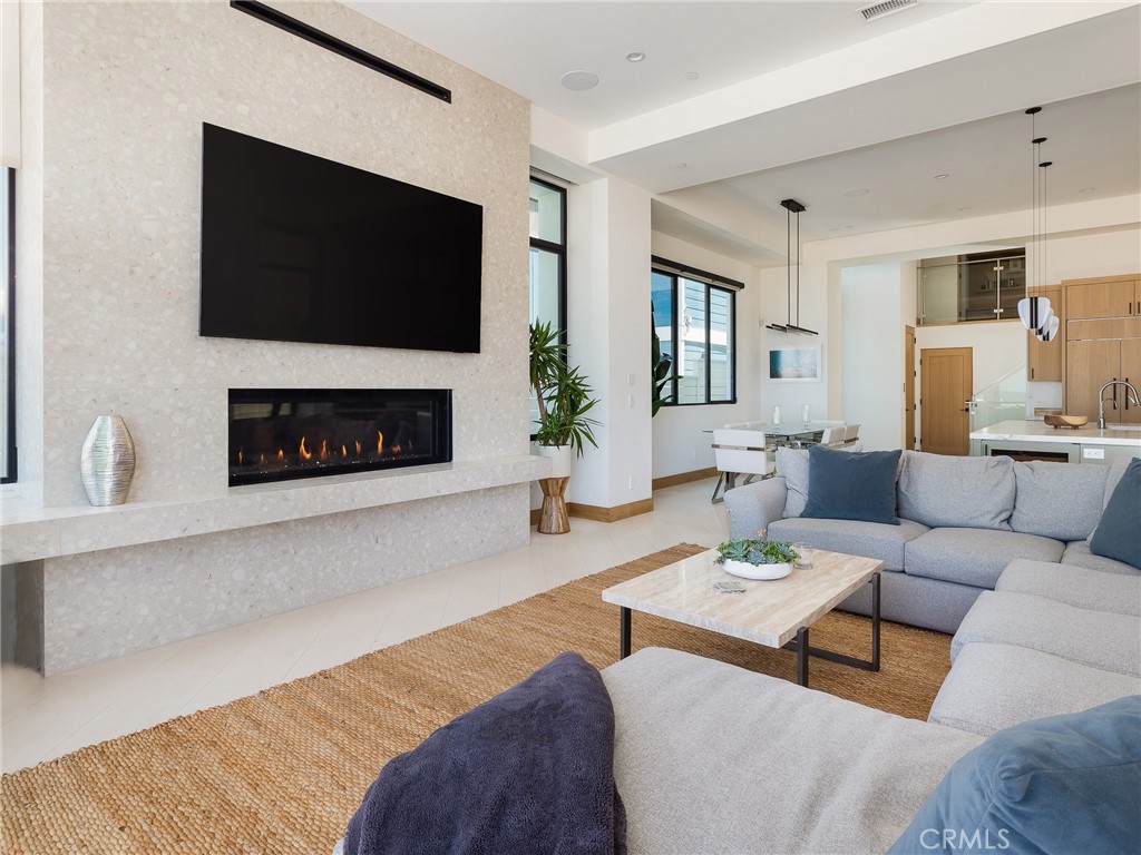 230 The Strand Hermosa Beach, CA 90254 - Photo 10 of 72 a living room with furniture a flat screen tv and a fireplace