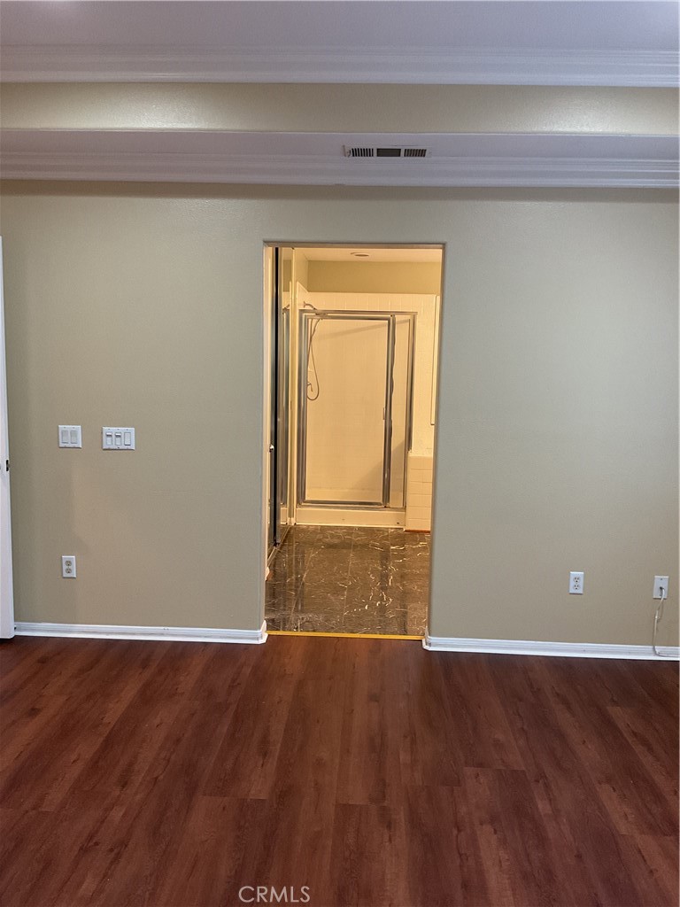 17636 Cypress Circle Carson, CA 90746 - Photo 18 of 29 a view of an empty room with wooden floor and a window
