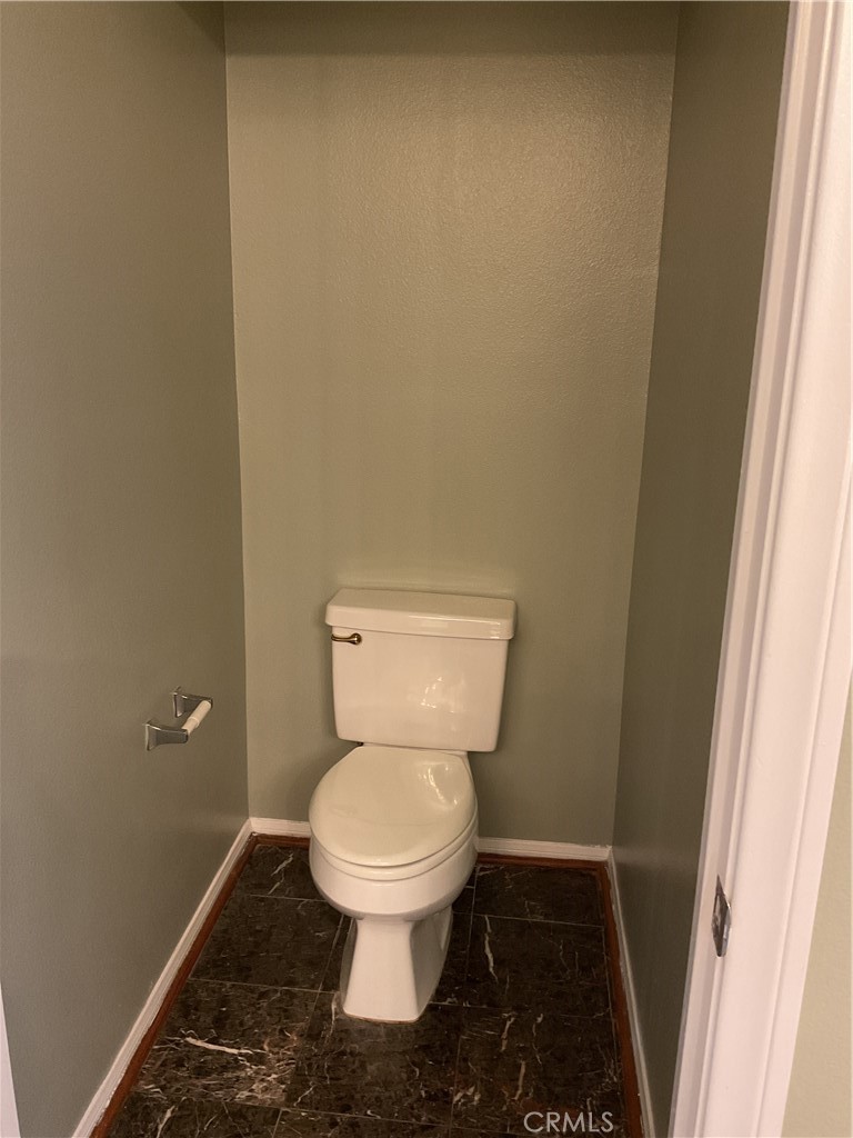 17636 Cypress Circle Carson, CA 90746 - Photo 24 of 29 a white toilet sitting in a bathroom