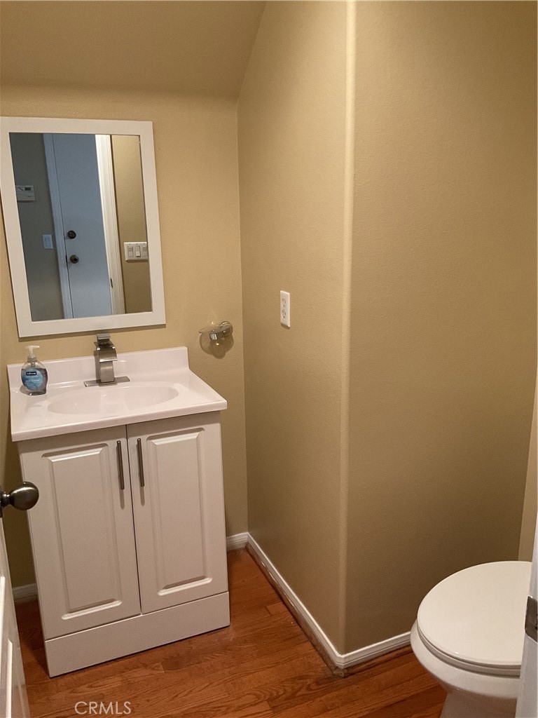 17636 Cypress Circle Carson, CA 90746 - Photo 4 of 29 a bathroom with a sink a toilet a mirror and vanity