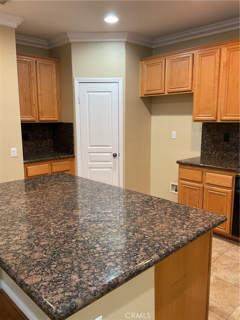 17636 Cypress Circle Carson, CA 90746 - Photo 9 of 29 a kitchen with kitchen island granite countertop a stove top oven a sink and a granite counter tops