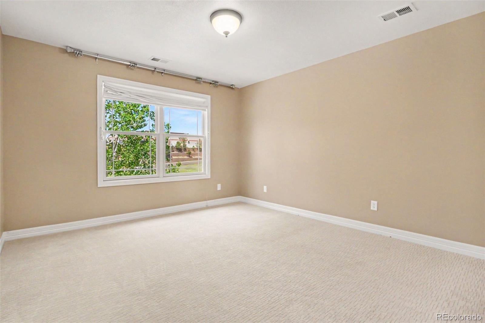791 Elk Rest Road Evergreen, CO 80439 - Photo 25 of 46 an empty room with windows