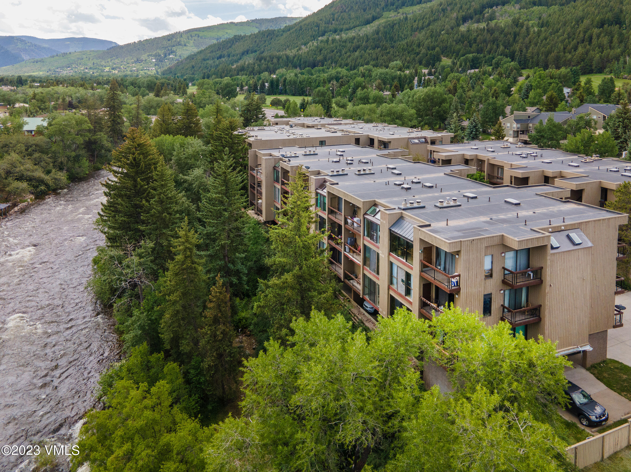 39377 Highway 6, Unit E205 Eagle Vail, CO 81620 - Photo 1 of 40 an aerial view of a house with a yard and large trees