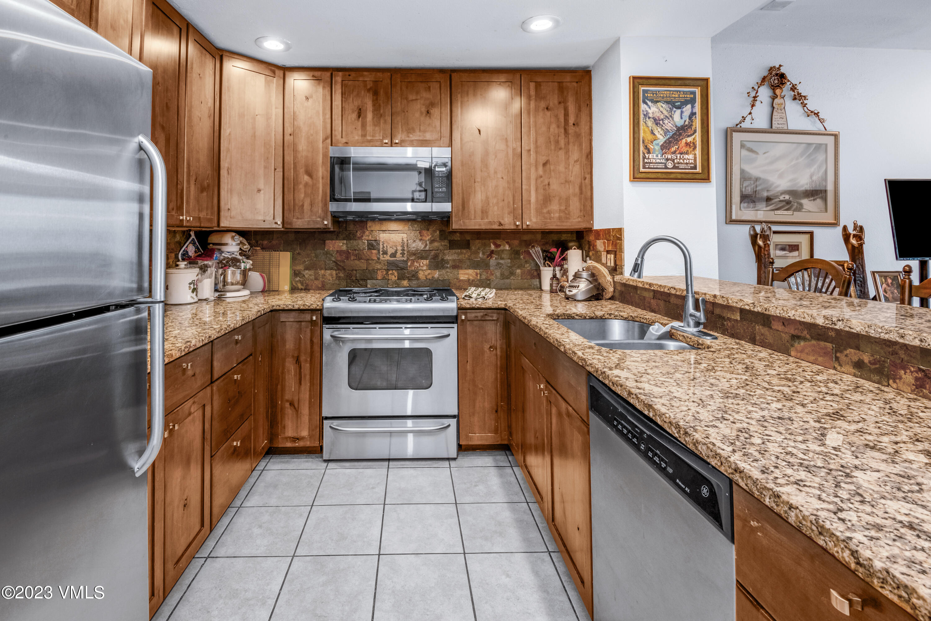 39377 Highway 6, Unit E205 Eagle Vail, CO 81620 - Photo 5 of 40 a kitchen with stainless steel appliances granite countertop a sink stove and refrigerator