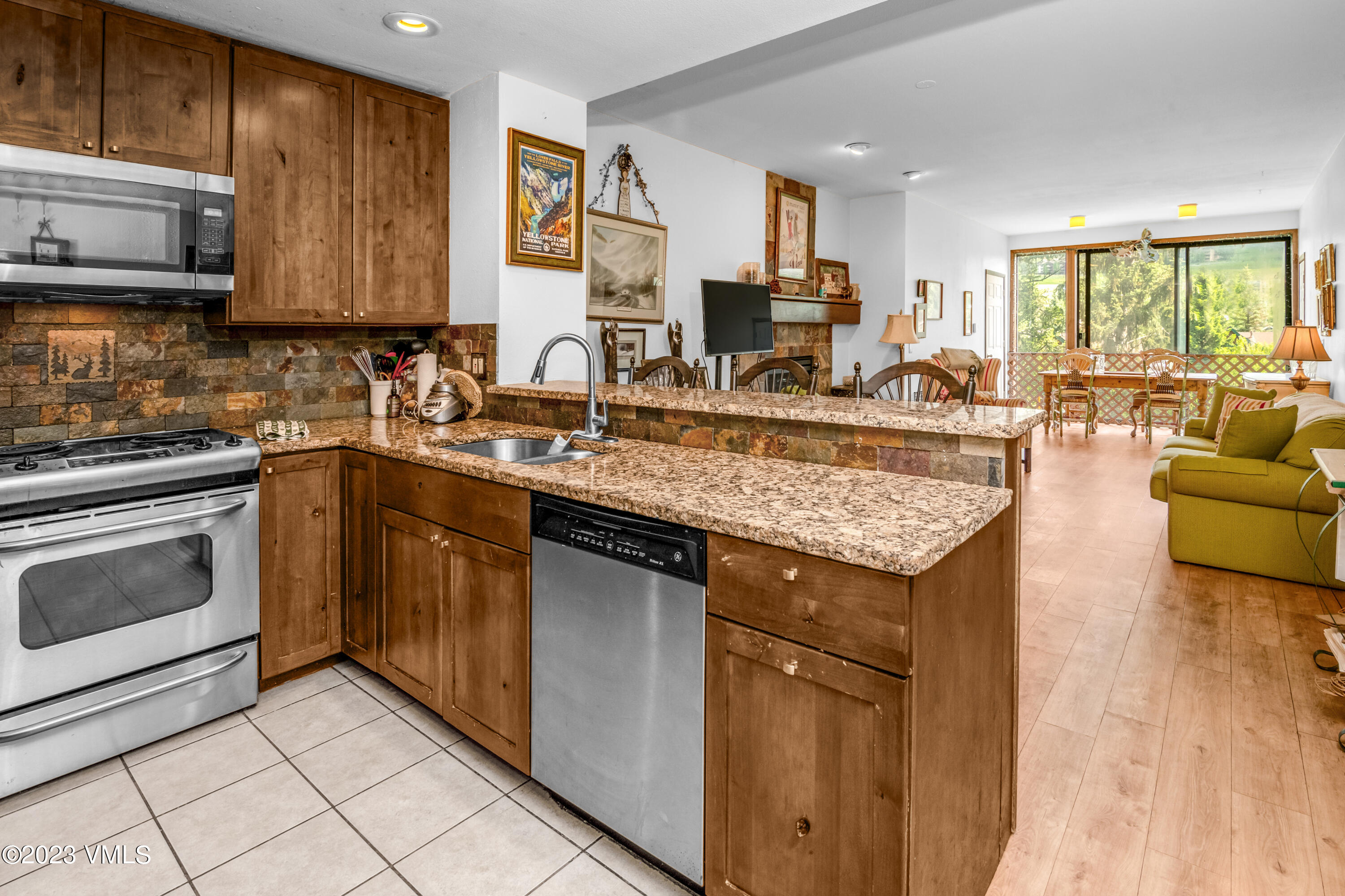39377 Highway 6, Unit E205 Eagle Vail, CO 81620 - Photo 6 of 40 a kitchen with stainless steel appliances granite countertop a stove sink and cabinets