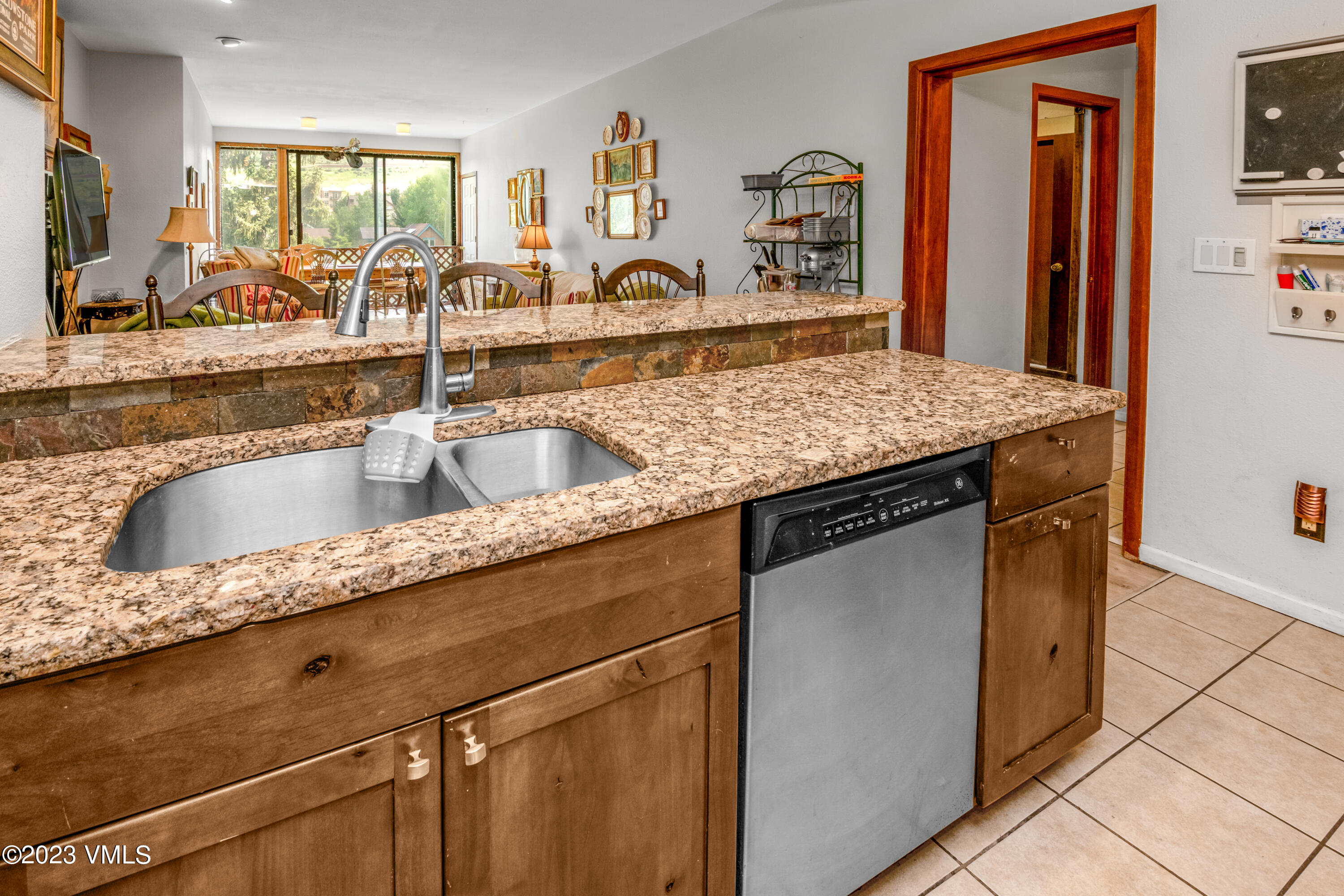 39377 Highway 6, Unit E205 Eagle Vail, CO 81620 - Photo 7 of 40 a kitchen with granite countertop a sink and a refrigerator