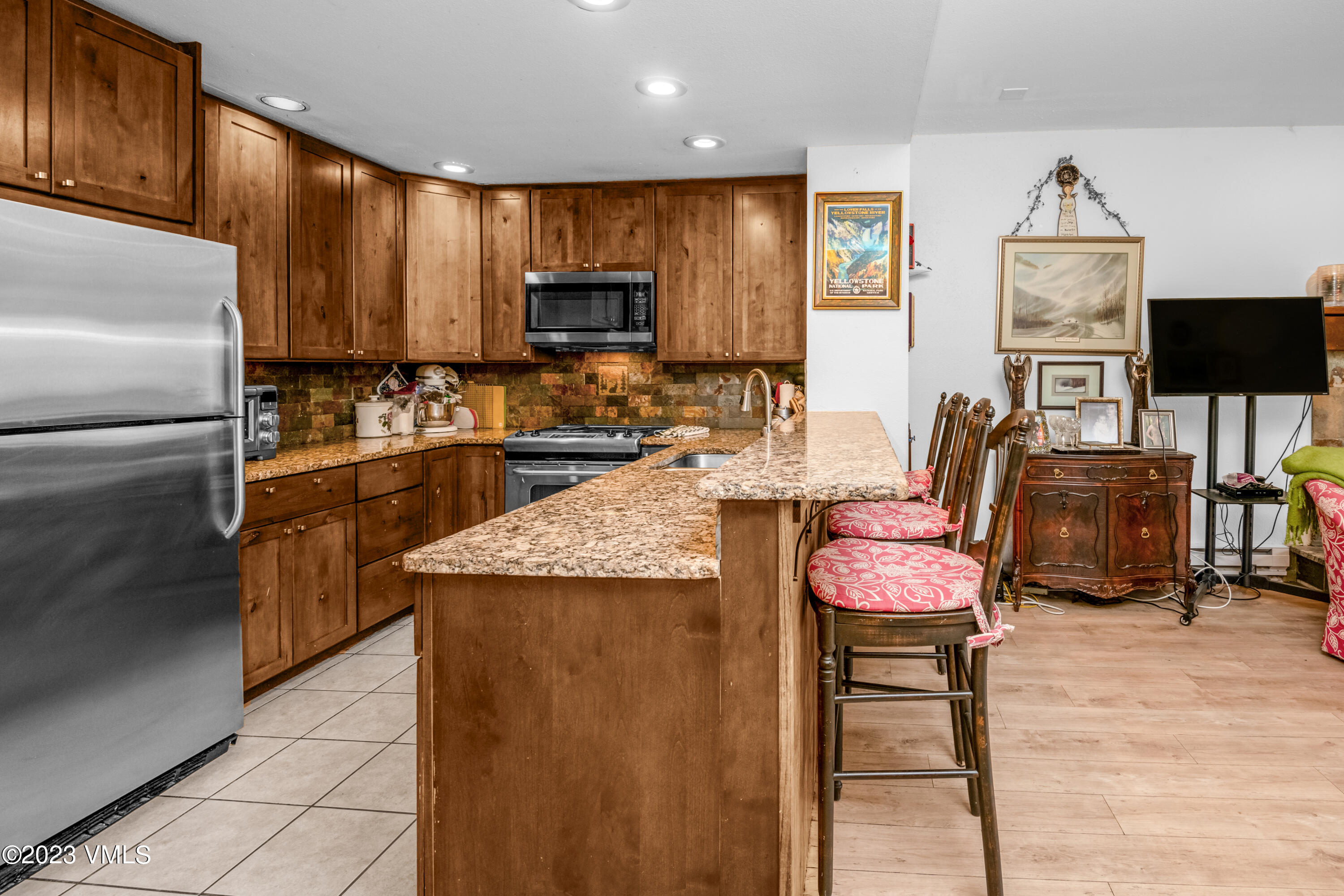 39377 Highway 6, Unit E205 Eagle Vail, CO 81620 - Photo 8 of 40 a kitchen with granite countertop a sink stainless steel appliances and cabinets