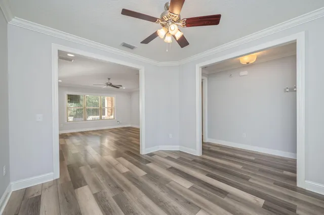 wooden floor in an empty room with a window