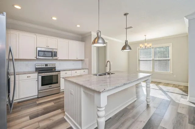 a kitchen with a stove oven and sink