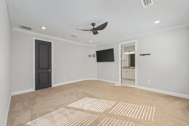 a view of an empty room with a ceiling fan