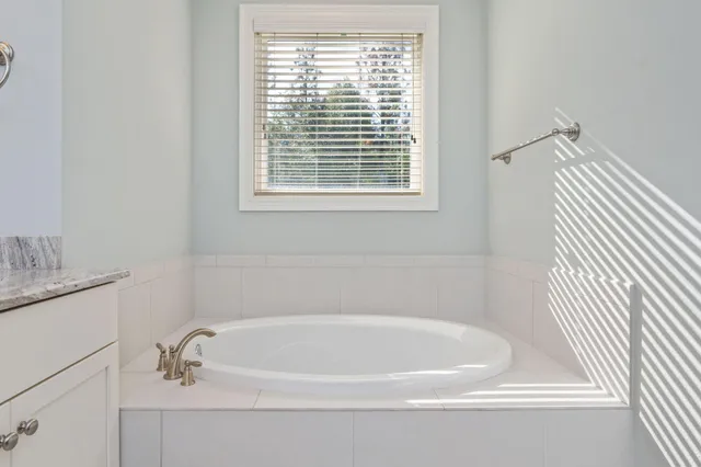 a white bath tub sitting next to a window