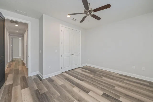 a view of a room with wooden floor