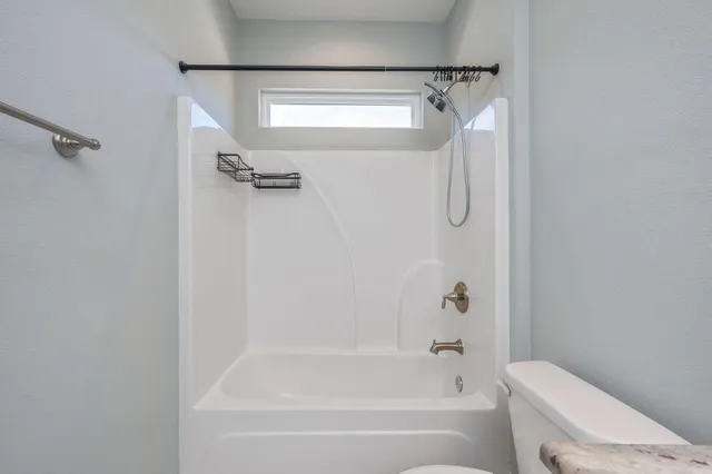 a bathroom with a shower and a toilet
