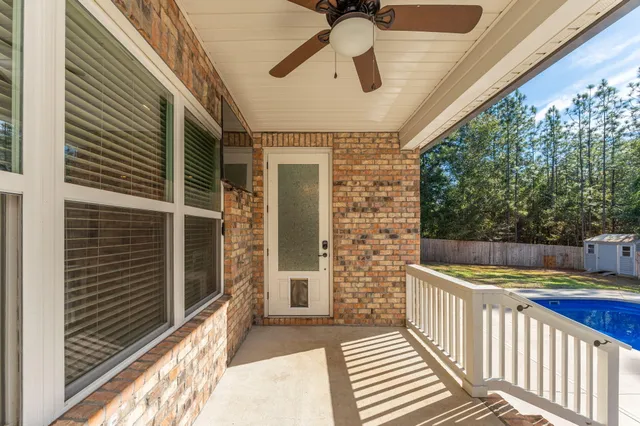 a view of a backyard with table and chairs with wooden fence