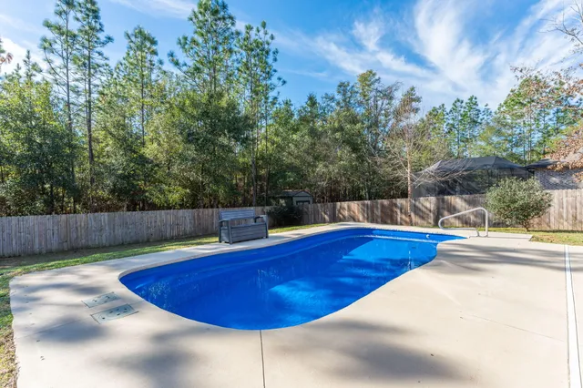 a view of a swimming pool and a yard